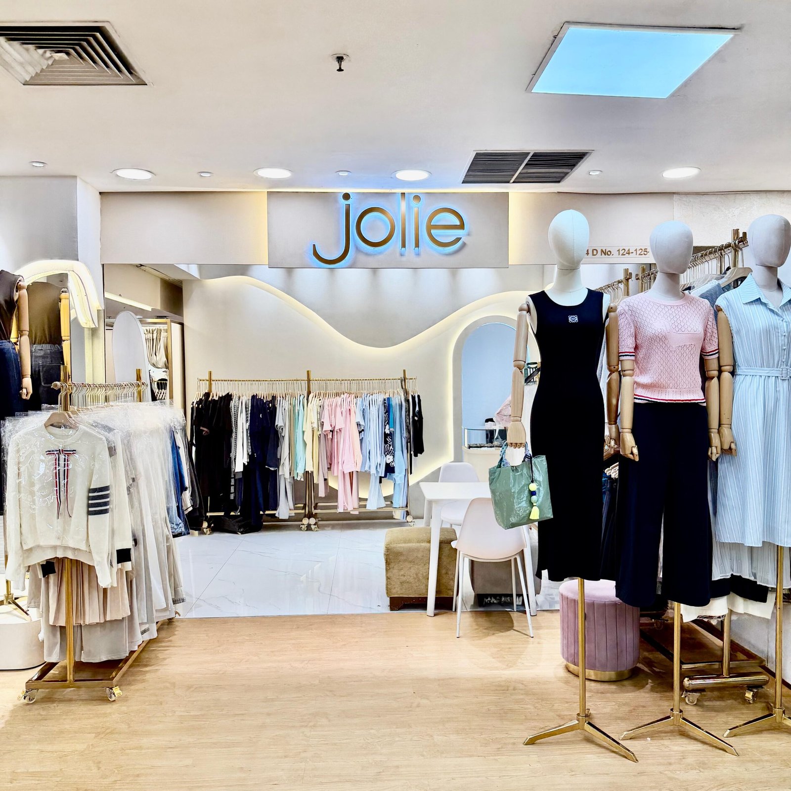 Inside the Jolie boutique at ITC Mangga Dua, with clothing racks and mannequins displaying the collection